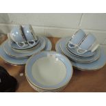 A Doulton four setting blue and gilt dinner service