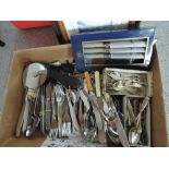 A box of various flatware