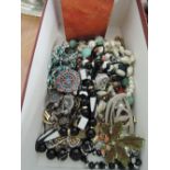 A box of costume jewellery including necklaces and broaches etc and treen inlaid playing card