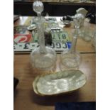 Two glass decanters and a pair of mother of pearl effect side dishes