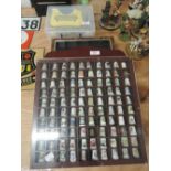 A collection of thimbles in display case and similar display case