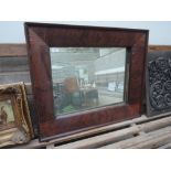 A rectangular wood framed mirror