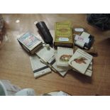 A selection of smoking items including matchbooks, lighter etc
