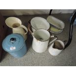 A selection of enamel jugs and storage jar etc