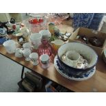 A selection of decorative ceramics including cranberry glass vase, souvenir egg cups and 1889