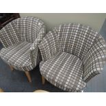 A pair of modern tubchairs, brown check pattern