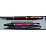 Two Waterman fountain pens, blue Phileas and burgundy Expert, also red ballpoint