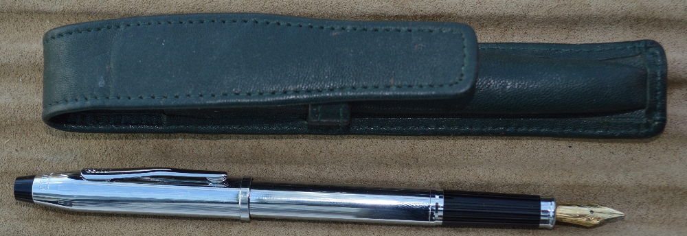 A Cross chrome fountain pen in leather wallet