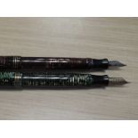 Two Parker Vacumatic fountain pens, a red and a green