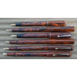 Six brown marbled fountain pens, including Unique, Typhoo tea, The Berkley, Ingersol, all have 14k