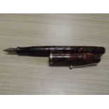 A Waterman lever fill fountain pen, Ideal regus nib, red marbled