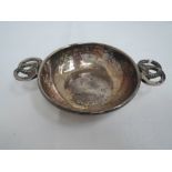 A small silver quaiche having moulded loop handles and planishing to bowl, Birmingham 1923, Albert
