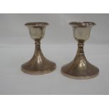 A pair of HM silver candlesticks of plain squat form, Chester and Birmingham hallmarks, S