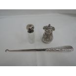 A Victorian silver pepperette of oval baluster form having frilled rim to pierced lid and