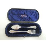 A cased Victorian silver spoon and fork set having extensive engraved decoration to front and