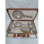 A cased silver dressing table set having engine turned decoration and initialled G, Birmingham 1911,