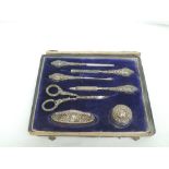 An Edwardian cased silver seven piece manicure set having moulded handles, Birmingham 1909, B & Co