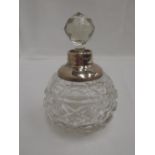 A cut glass perfume bottle of spherical form having an HM silver collar and glass stopper