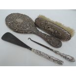 Four pieces of HM silver dressing items including hand mirror, brush, shoe horn and button hook