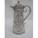 An American mid 19th century coin silver coffee pot having extensive repousse floral and scroll