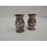 A pair of small Victorian silver posy vases of twist form having fluted rims, Birmingham 1890, E S