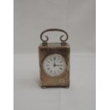 A small Edwardian silver carriage clock of plain rectangular form containing a French movement and