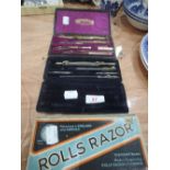 Two cased drawing instrument sets and a Rolls Razor, boxed