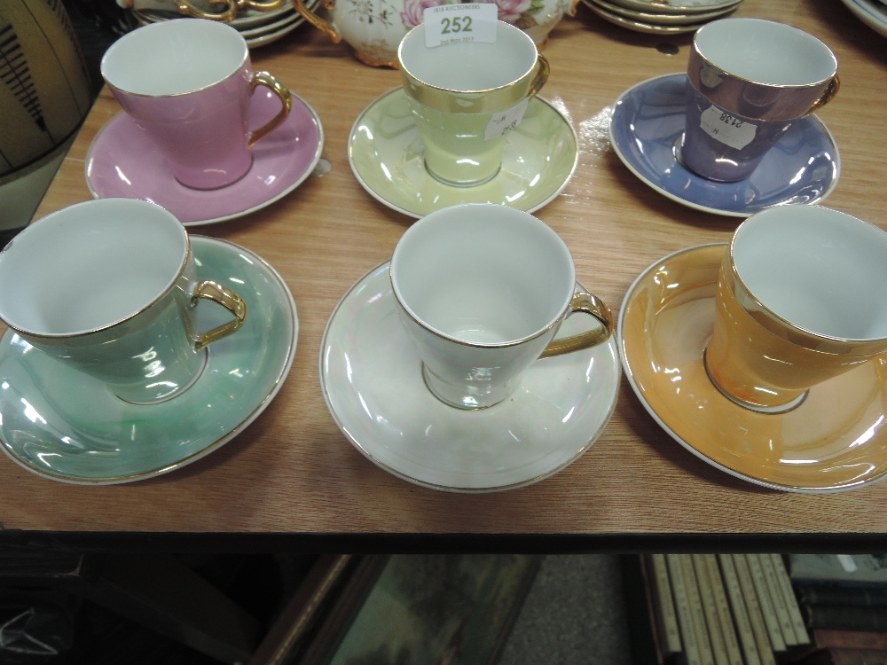 A harlequin set of six coffee cups and saucers