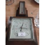 An oak framed barometer and thermometer