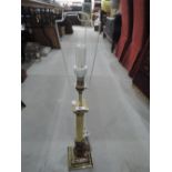 A brass effect column table lamp