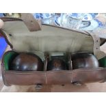 A set of crown green bowls in a leather case