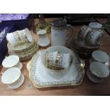 A Cauldon part tea service white with gilt and foliate design