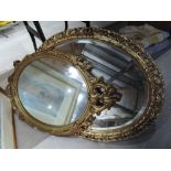 Two gilt framed oval mirrors