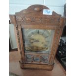 An oak framed mid 20th Century mantle clock