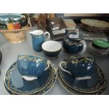 A Royal Worcester tea for two service having gilt heightened garland on blue ground