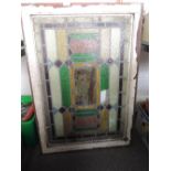 A stained glass window in frame (one broken pane)