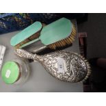 Three enamel and glass table pieces and a silver dressing table brush having raised leaf and berry