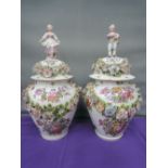 A pair of bourdois and block lidded jars in the Meissen style having floral encrusted decoration