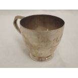 A silver tea cup of plain form having inscription to front, Sheffield 1926, Walker & Hall