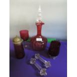 A cranberry glass decanter with clear glass stopper, a cranberry wine glass, jug, sifter and a