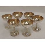 A set of six Victorian silver champagne coupes of plain form having gilt bowls, Birmingham 1898,