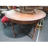 A late Victorian mahogany centre table having circular top on reeded and turned legs with cross