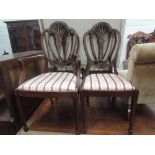 A set of five (3+2) Edwardian mahogany salon dining chairs in the Hepplewhite style having crest