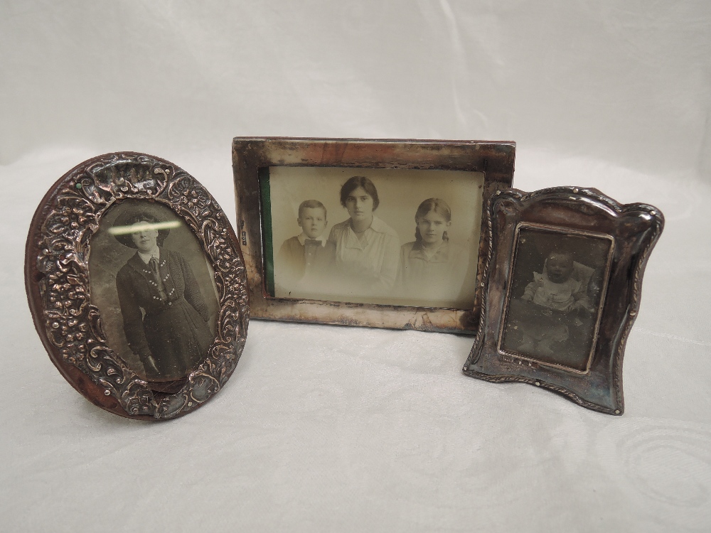 Three small HM silver photograph frames of various forms