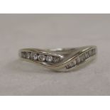 A lady's wishbone dress ring having brilliant and baguette cut diamonds in a channel setting on a