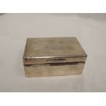 A silver cigarette box of plain form having monogram to lid, London 1954, Padgett & Braham Ltd