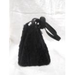 A black pony skin and grosgrain pyramid form evening bag by Waldybag having black silk lining and
