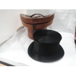 A gents silk top hat with cream calf leather and silk interior, with leather lockable fitted hat box