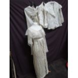 An Edwardian style cream silk dress having beaded panel and lace shawl collar, two ivory coloured