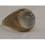 A gents yellow metal signet ring stamped 14k having a moonstone cabouchon stone to bark effect